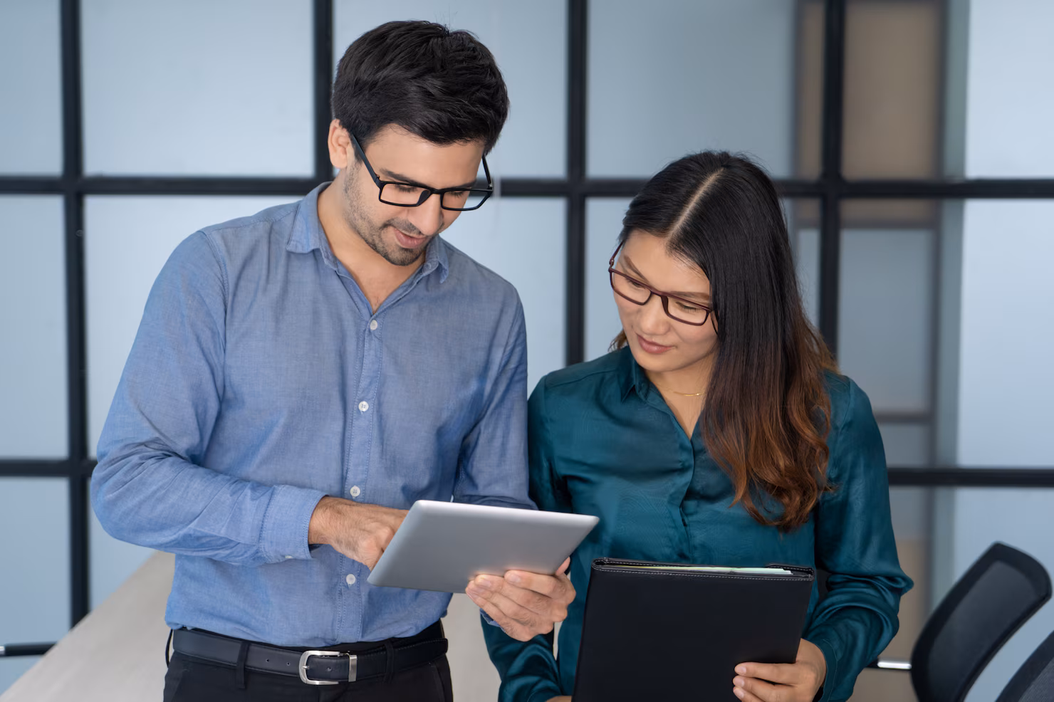 caucasian supervisor helping new asian employee 1262 12619