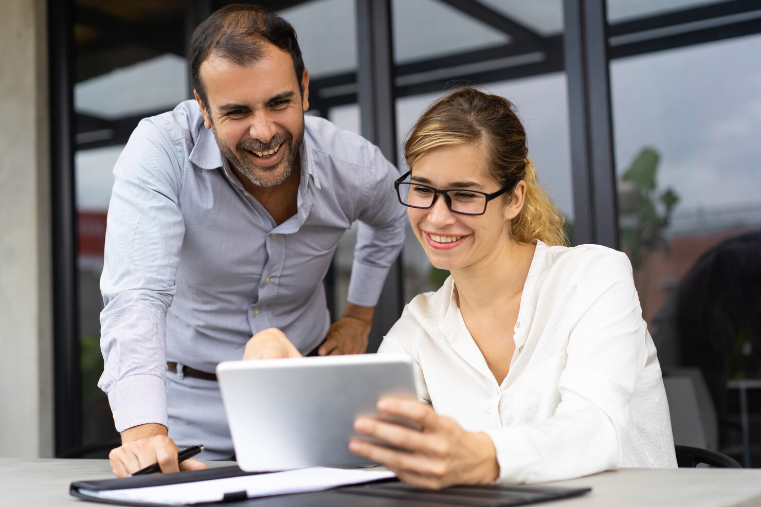 portrait cheerful colleagues discussing documents tablet 1262 17954